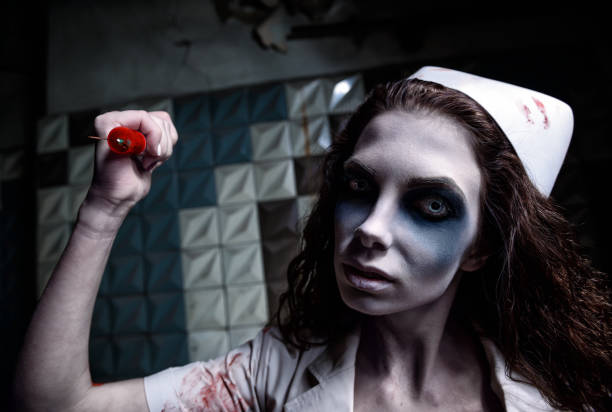 horror-shot-scary-evil-insane-nurse-attacking-by-bloody-syringe-picture-id1038281434.jpg