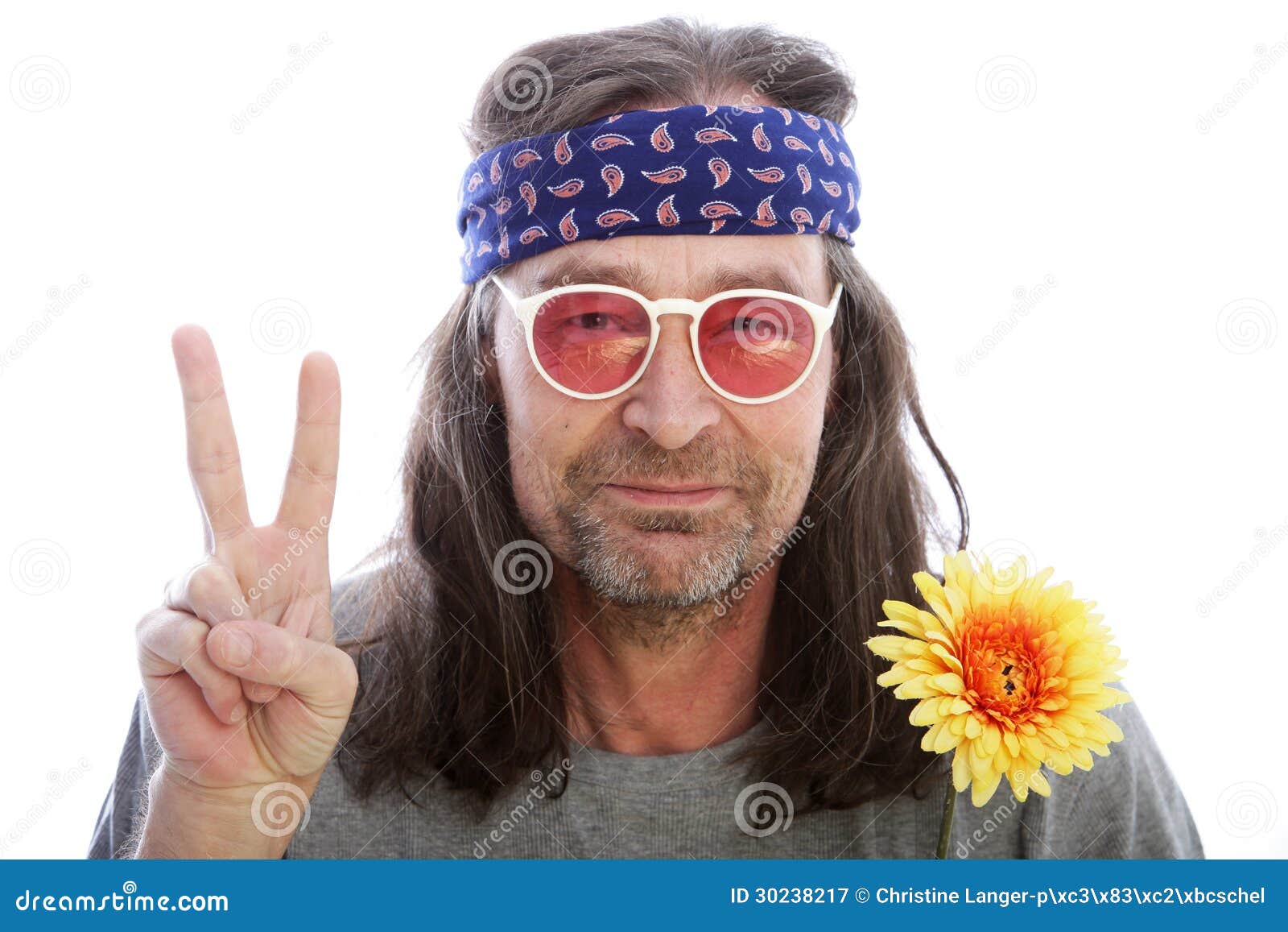 unshaven-male-hippie-long-shoulder-length-hair-wearing-headband-yellow-flower-rose-coloured-glasses-making-peace-sign-30238217.jpg