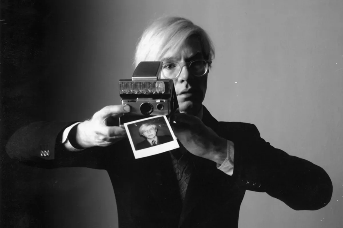 Andy-Warhol-with-a-Polaroid-Camera-thumbnail_webp-9999x9999.webp